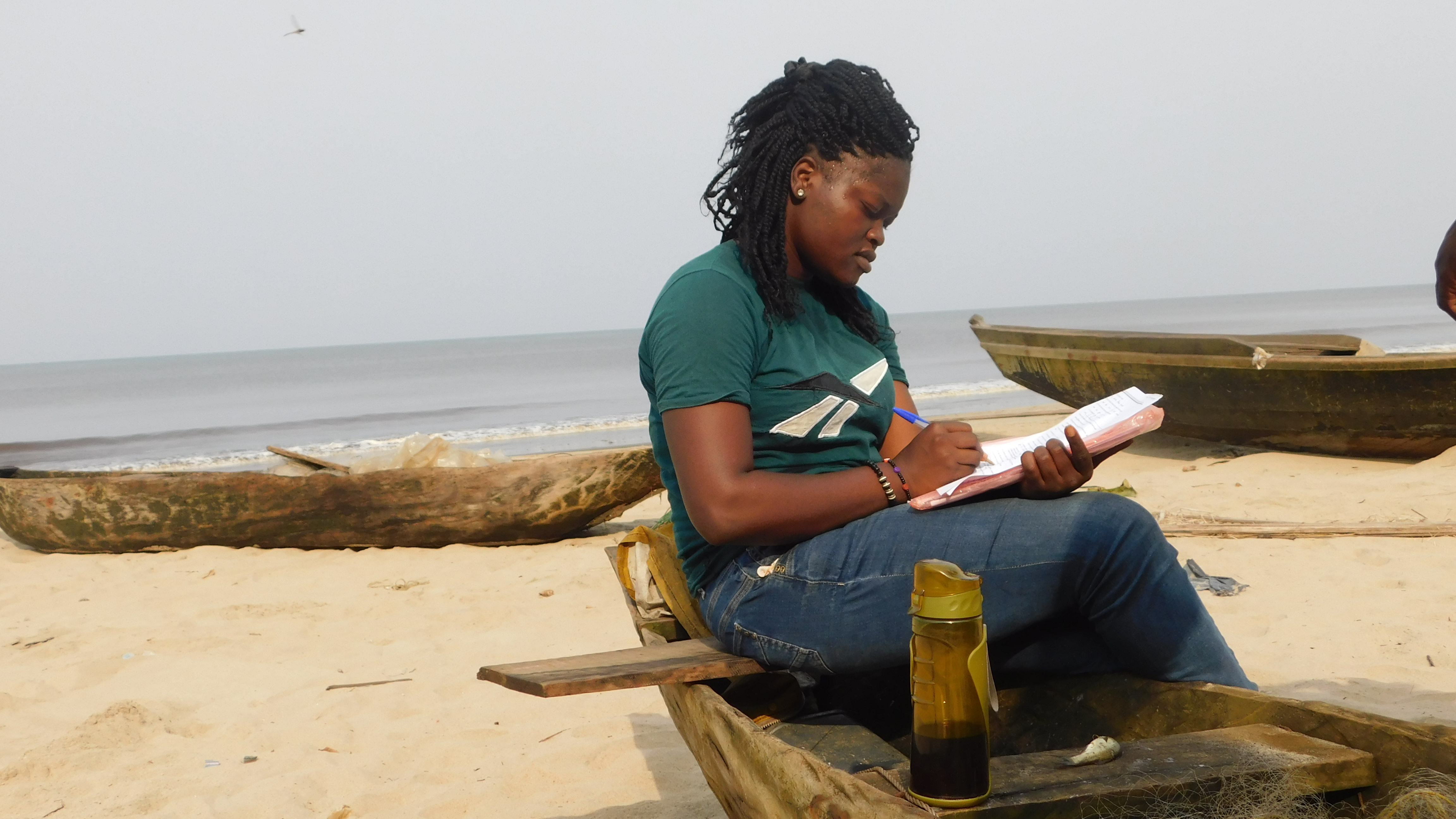 Ursla Koumbo conducting field research on a beach